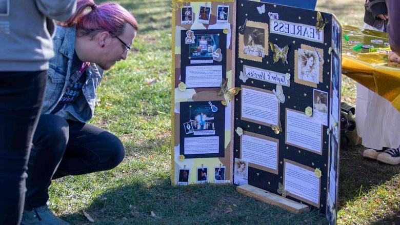 Community member reading student's research poster